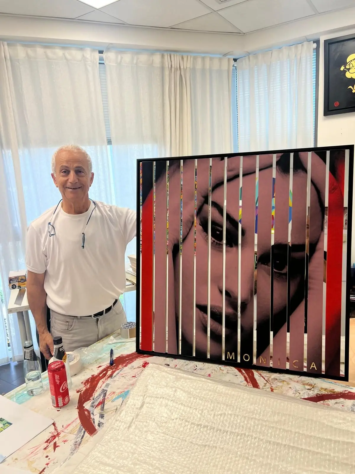 A client standing beside his artwork